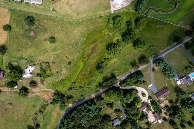 an aerial view of residential houses with outdoor space
