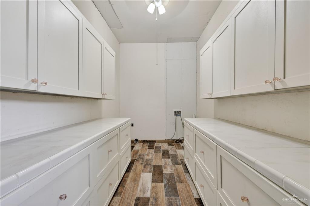 1424 North Sky Soldier Road Weslaco, TX 78596 - Photo 25 of 33 a view of a kitchen with white cabinets