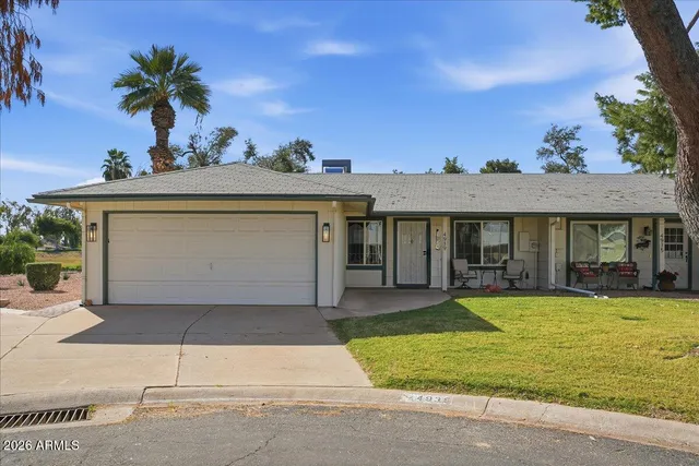 a view of a house with swimming pool and a yard with a sitting area