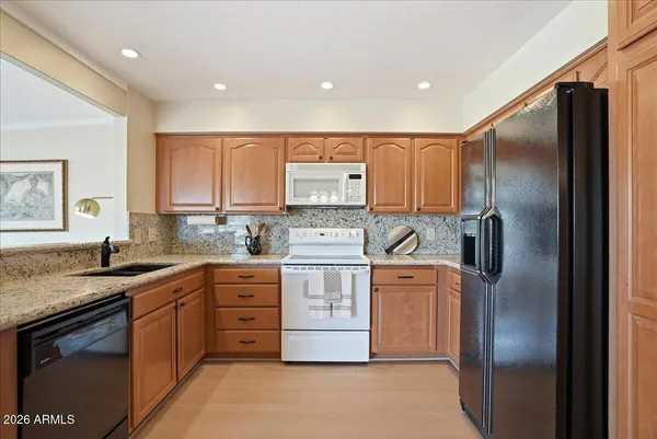a kitchen with stainless steel appliances granite countertop a stove and a sink