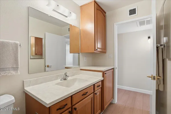 a bathroom with a granite countertop sink toilet and shower