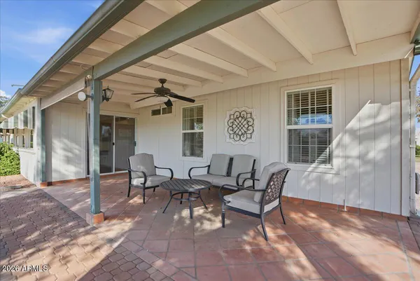 a view of a porch with furniture and a yard
