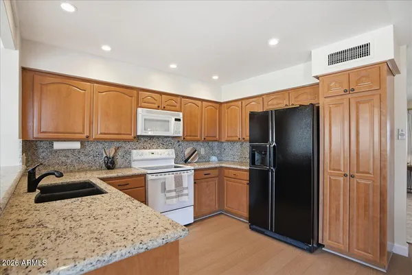 a kitchen with a table chairs sink and cabinets