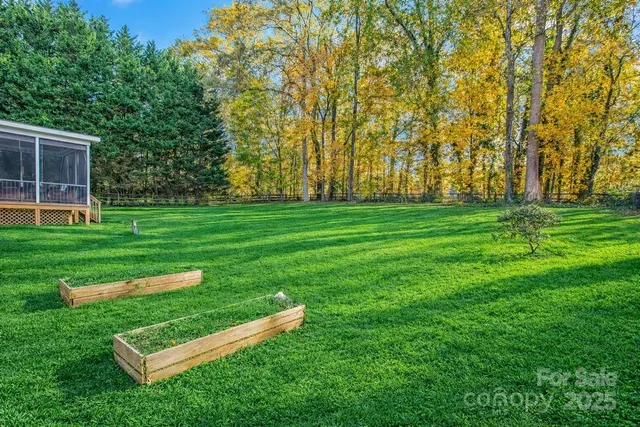a view of a park with wooden fence