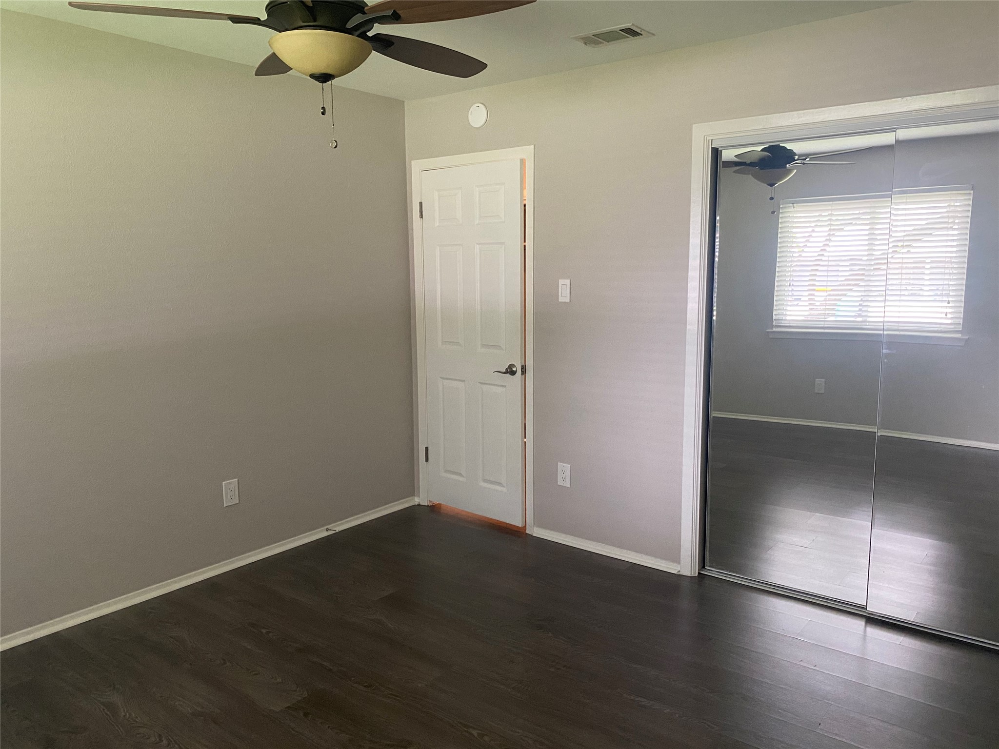 11505 Windermere Meadows Austin, TX 78759 - Photo 11 of 16 an empty room with wooden floor closet and windows