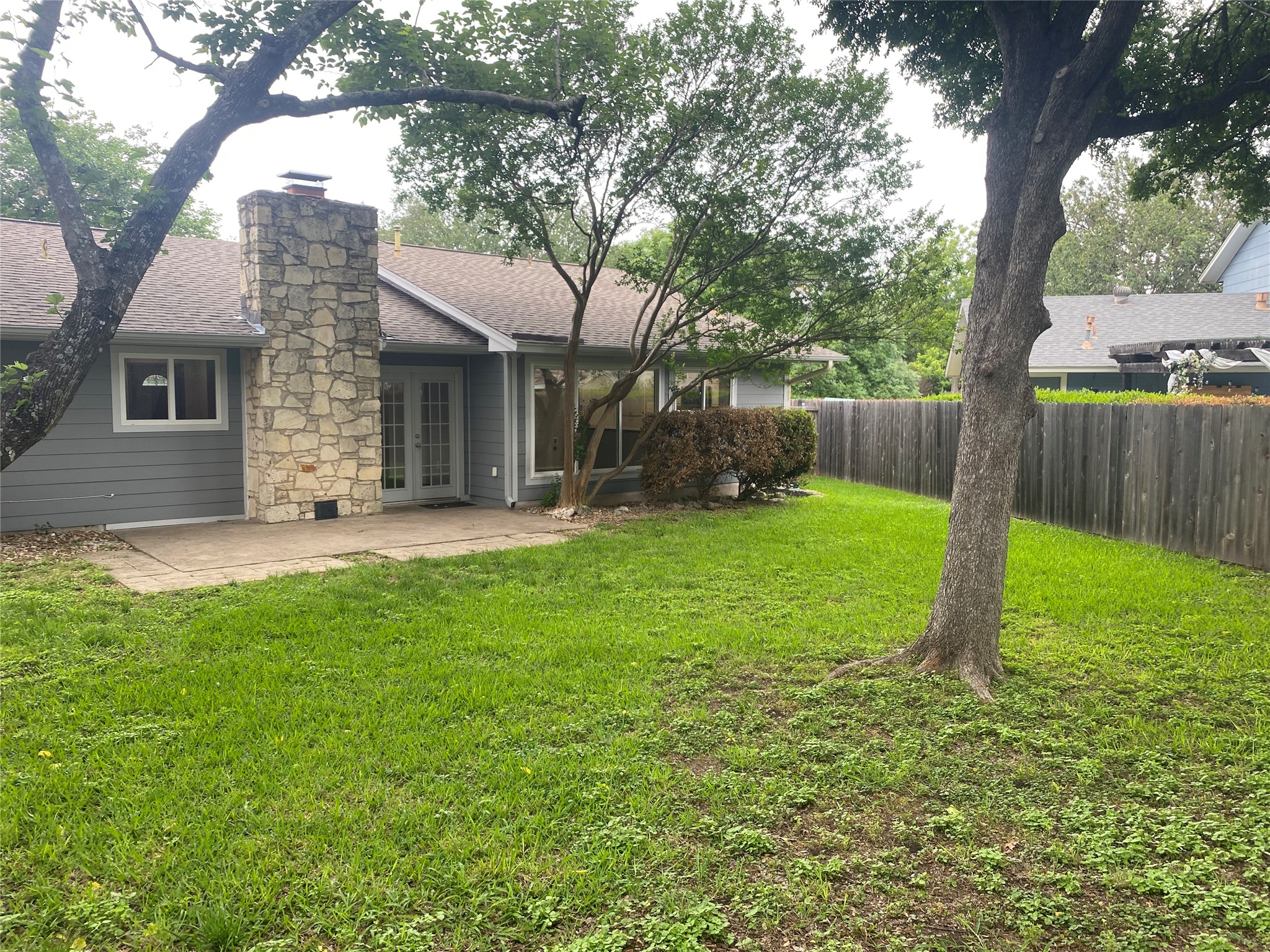 11505 Windermere Meadows Austin, TX 78759 - Photo 16 of 16 a view of a house with backyard and a tree