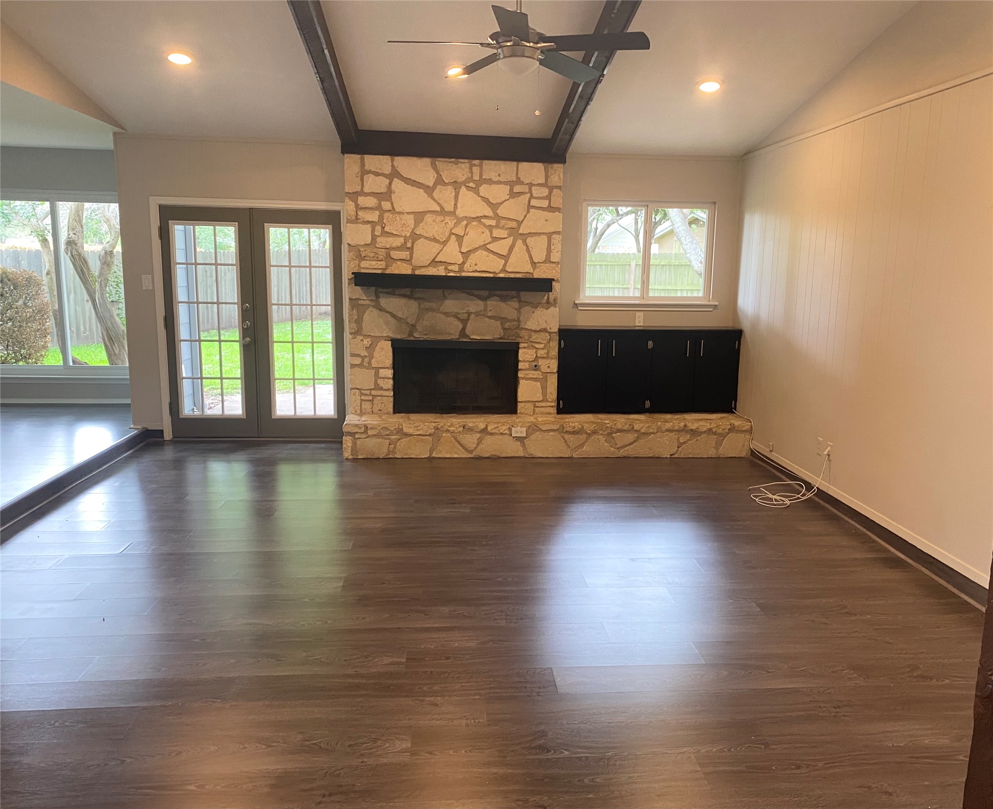 11505 Windermere Meadows Austin, TX 78759 - Photo 2 of 16 an empty room with wooden floor fireplace and windows