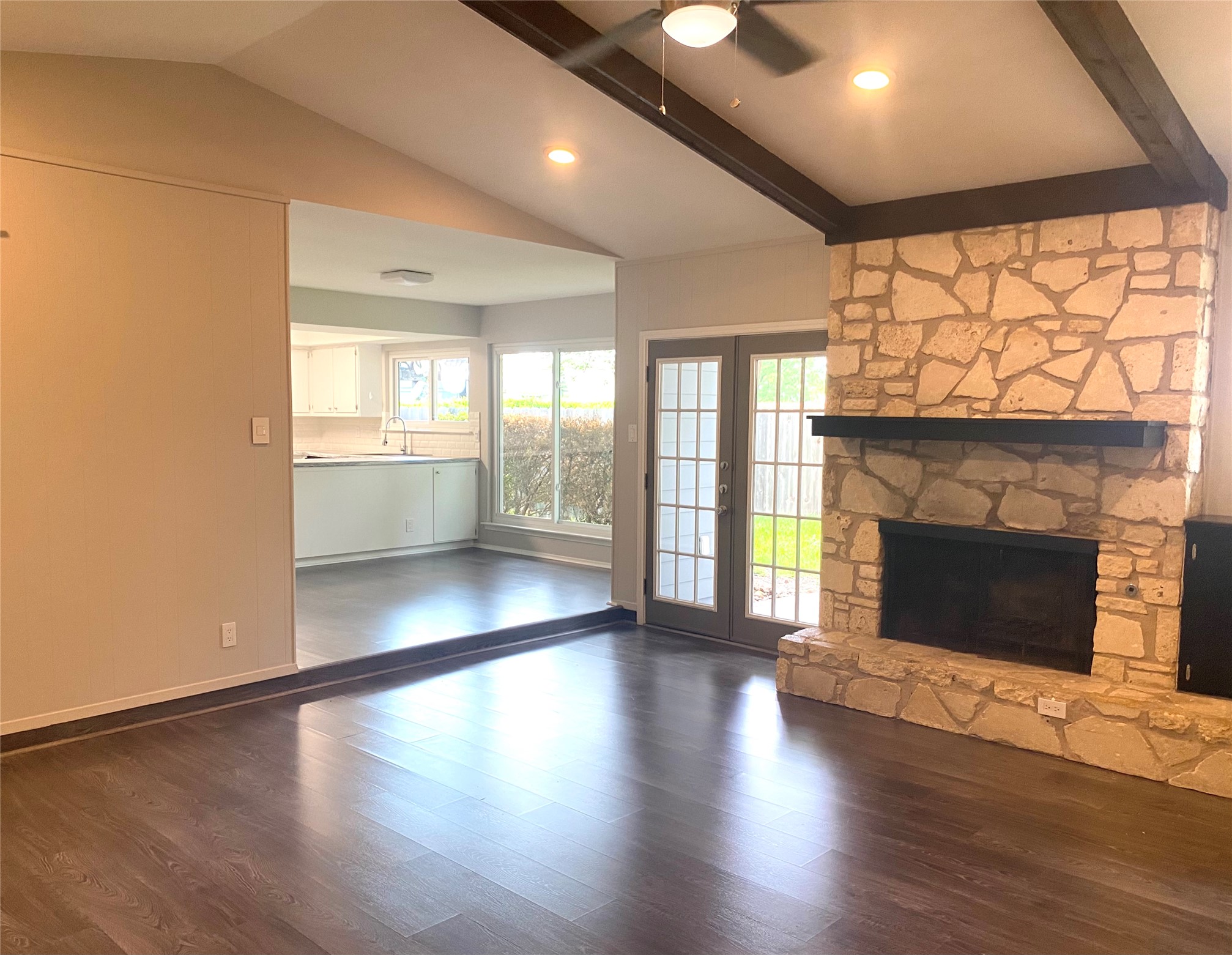 11505 Windermere Meadows Austin, TX 78759 - Photo 3 of 16 an empty room with wooden floor fireplace and windows