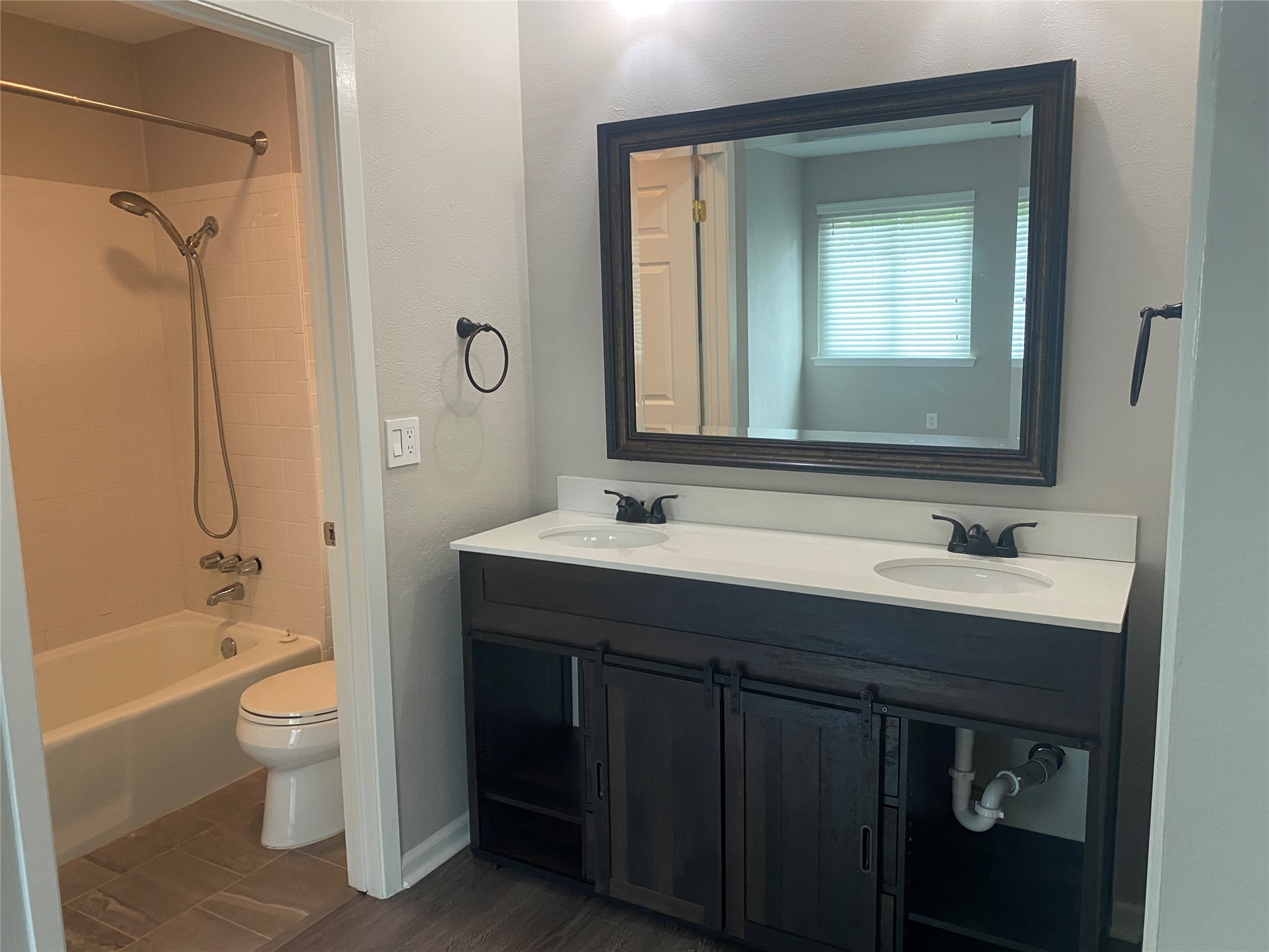 11505 Windermere Meadows Austin, TX 78759 - Photo 9 of 16 a bathroom with a double vanity sink toilet mirror and bathtub