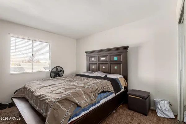 a bedroom with a bed and a window