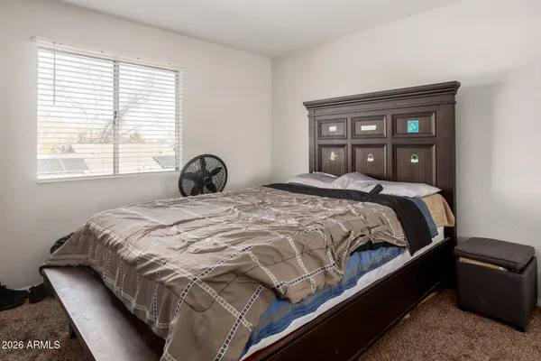 a bedroom with a bed and window