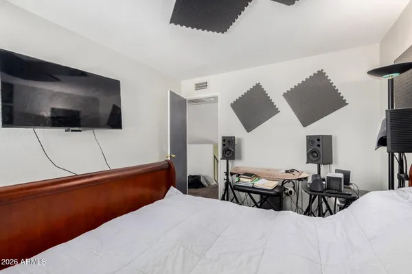 a bedroom with furniture and a flat screen tv
