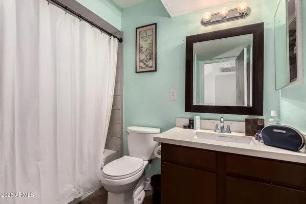 a bathroom with a toilet a sink and a mirror