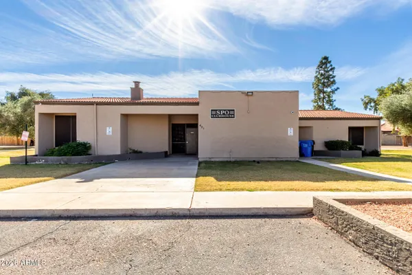 a view of swimming pool with small pool in front of house