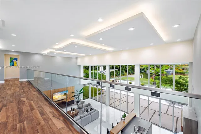 a bedroom with a bed and a lamp on dresser