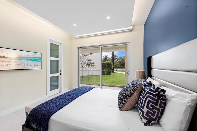 a bedroom with a bed and a painting on the wall