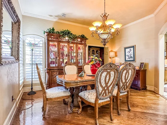 a bedroom with a bed a chair and a chandelier
