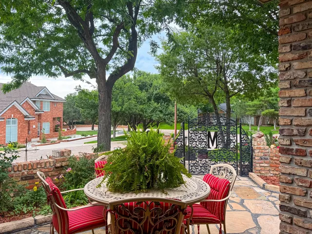 a view of a house with a yard and tree