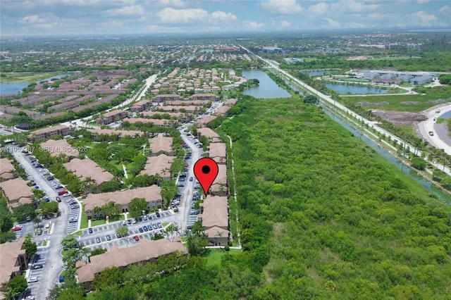 an aerial view of residential houses with outdoor space and river