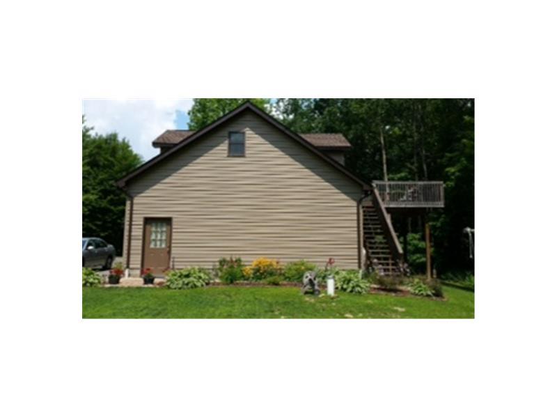 116 Hughes Road Hilliards, PA 16040 - Photo 2 of 18 Exterior Front. Side view showing the back deck. Enjoy relaxing out here while enjoying the wildlife.