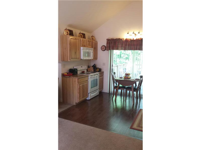 116 Hughes Road Hilliards, PA 16040 - Photo 5 of 18 Kitchen. Notice the beautiful flooring and the sliding doors to the deck.