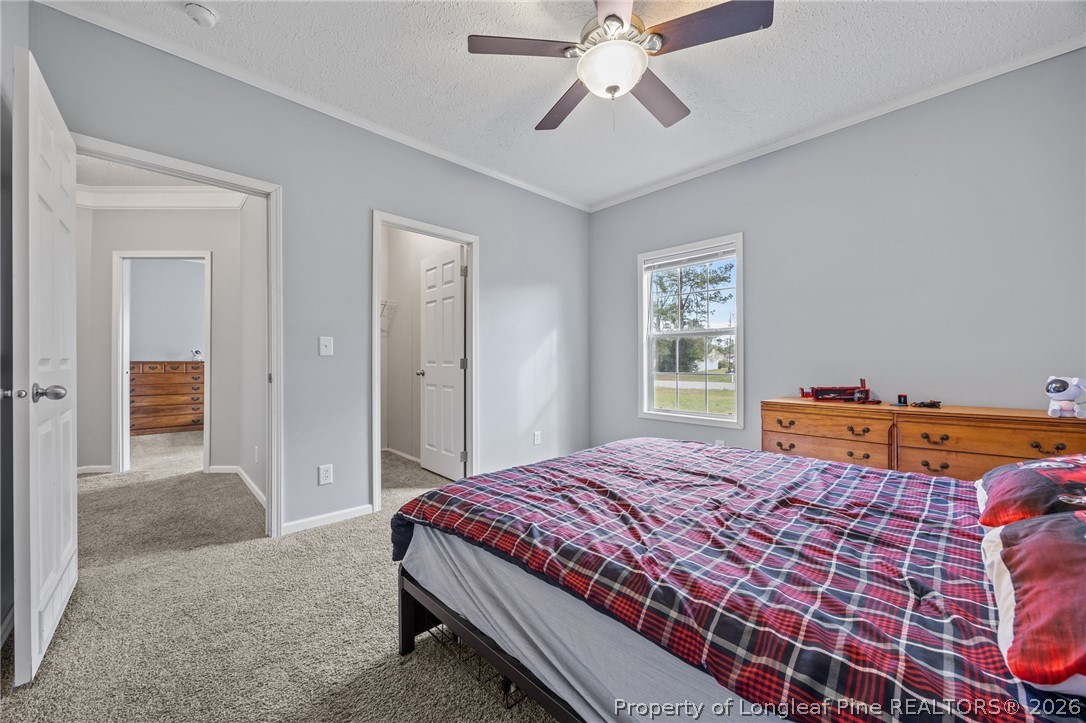 2252 Old Stage Road South Erwin, NC 28339 - Photo 18 of 47 a bedroom with a bed and a chandelier