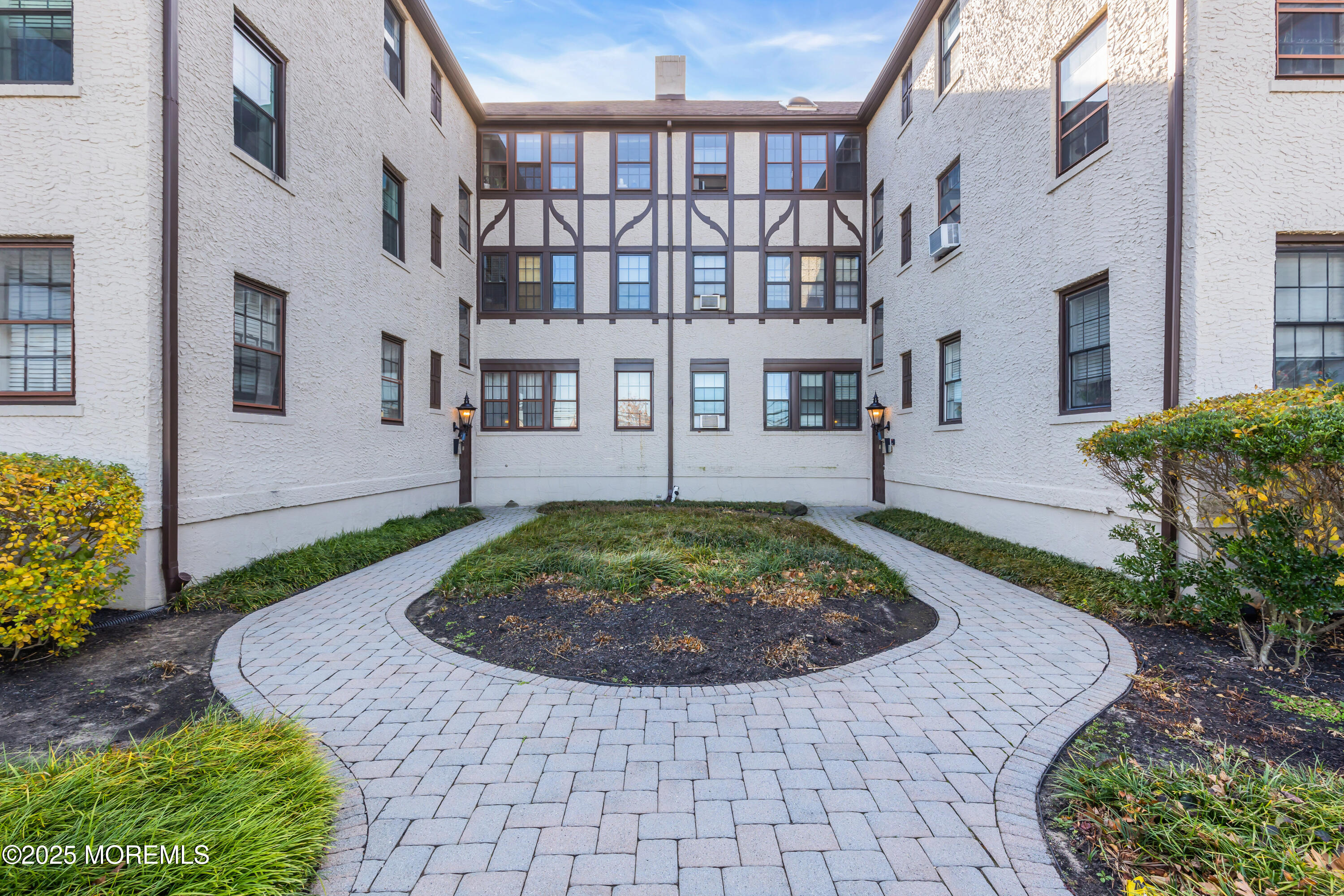 17 Leroy Place, Unit 2B Red Bank, NJ 07701 - Photo 20 of 24 a view of a brick house with a yard