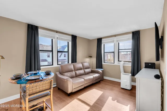 a living room with furniture and windows