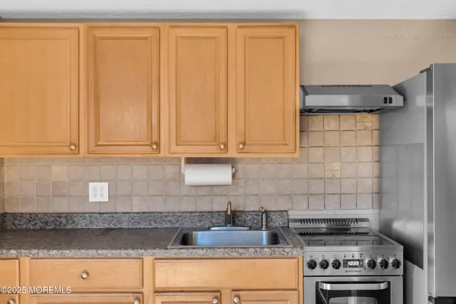 a kitchen with appliances cabinets and a counter top space