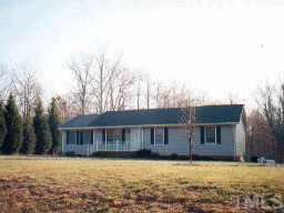 627 Edwards Road Henderson, NC 27537 - Photo 1 of 1 a front view of a house with yard and trees