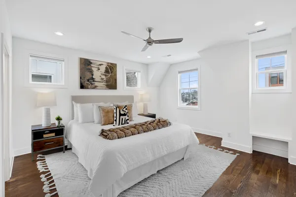 a bedroom with a bed and wooden floor