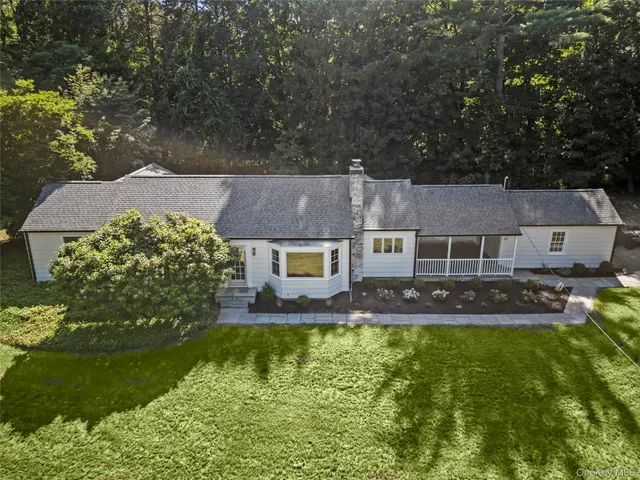 an aerial view of a house with swimming pool yard and outdoor seating