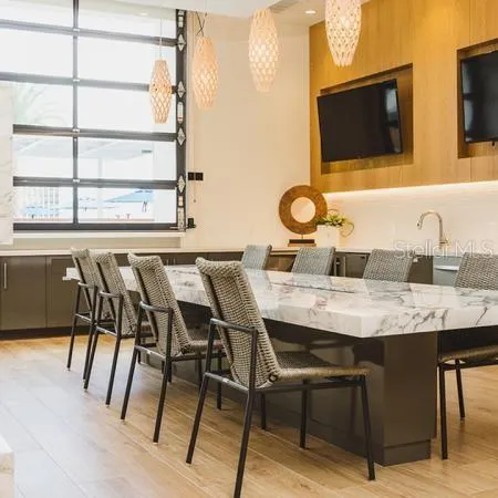 a kitchen with a table chairs and a sink