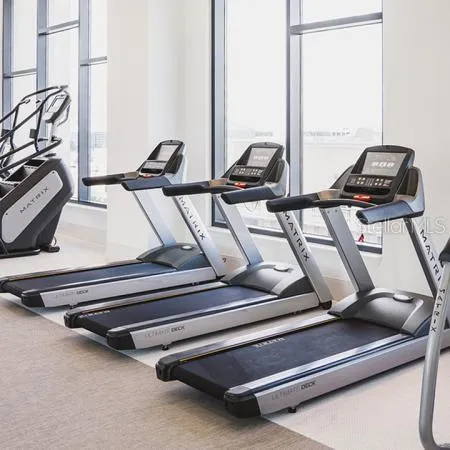 a view of gym equipment with a view of living room