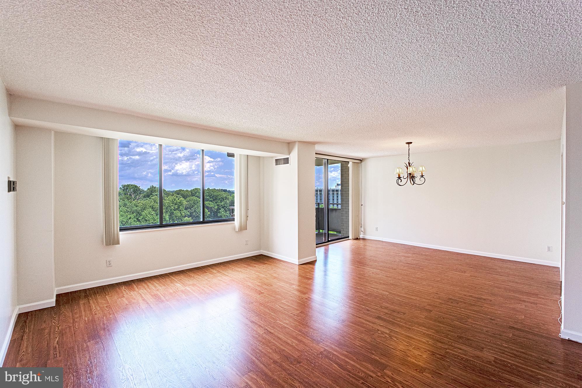 5225 Pooks Hill Road, Unit 721S Bethesda, MD 20814 - Photo 4 of 22 a view of an empty room with wooden floor and a window