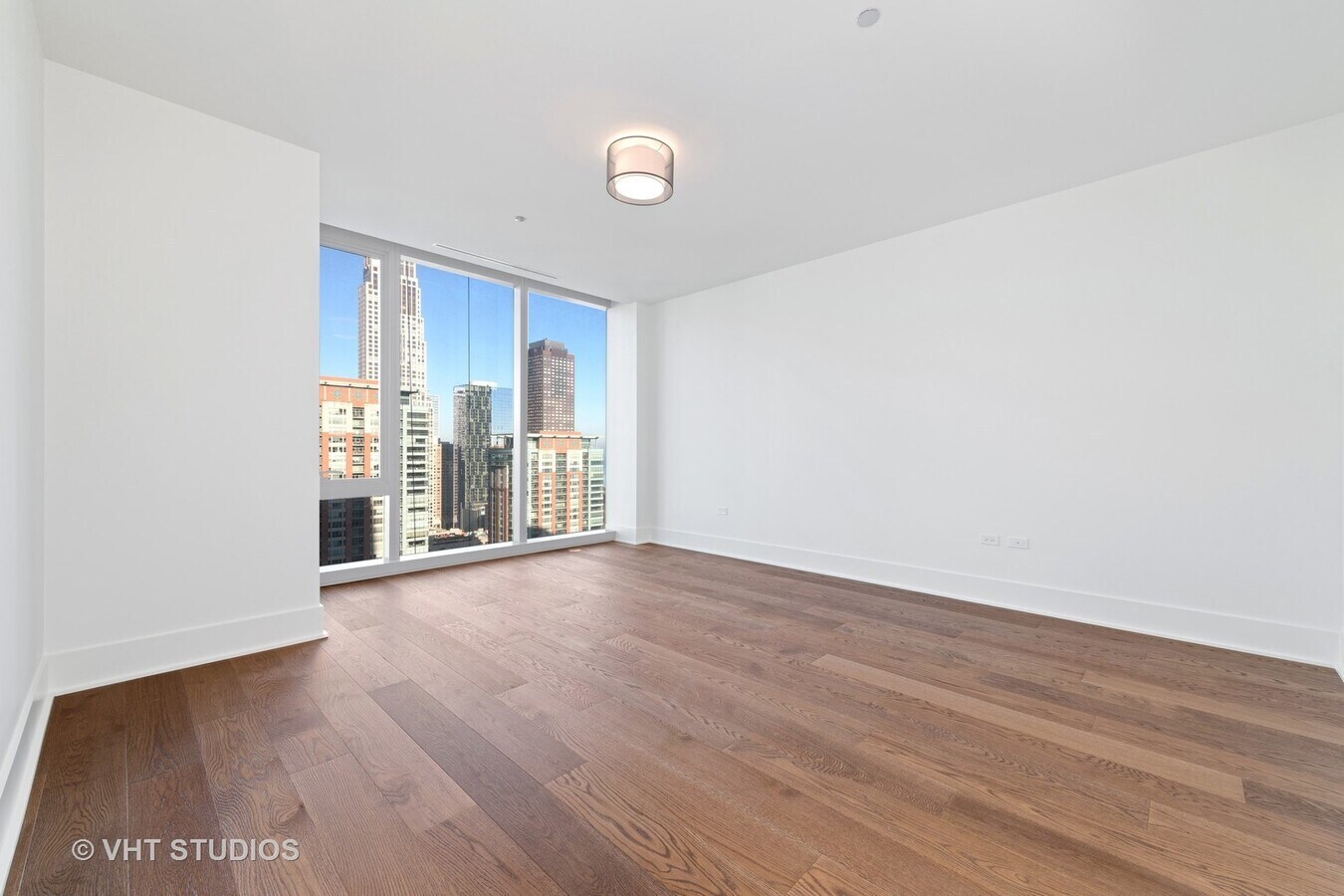Undisclosed Address Chicago, IL 60601 - Photo 14 of 21 a view of an empty room with wooden floor and a window