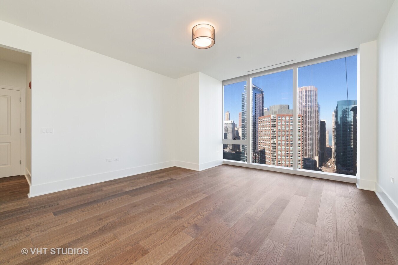 Undisclosed Address Chicago, IL 60601 - Photo 15 of 21 a view of an empty room with wooden floor and a window