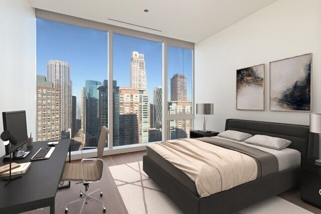 Undisclosed Address Chicago, IL 60601 - Photo 18 of 21 a bedroom with a large bed and a flat tv screen on dresser