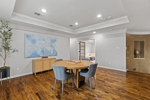a dining room with furniture and wooden floor