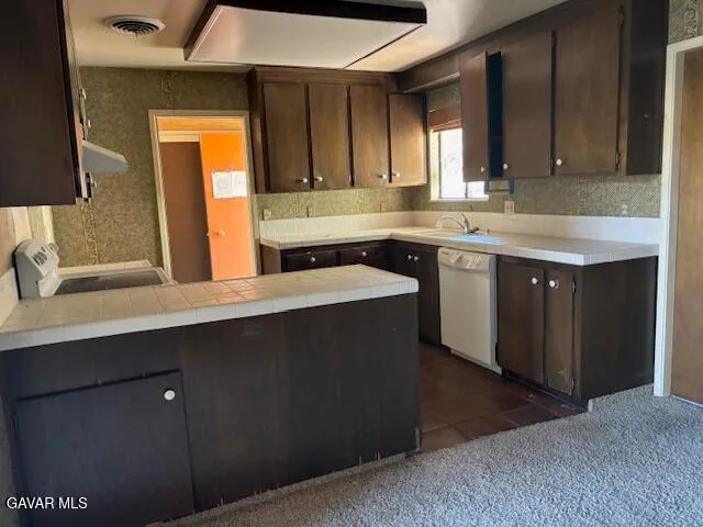 a kitchen with a sink a cabinets and window