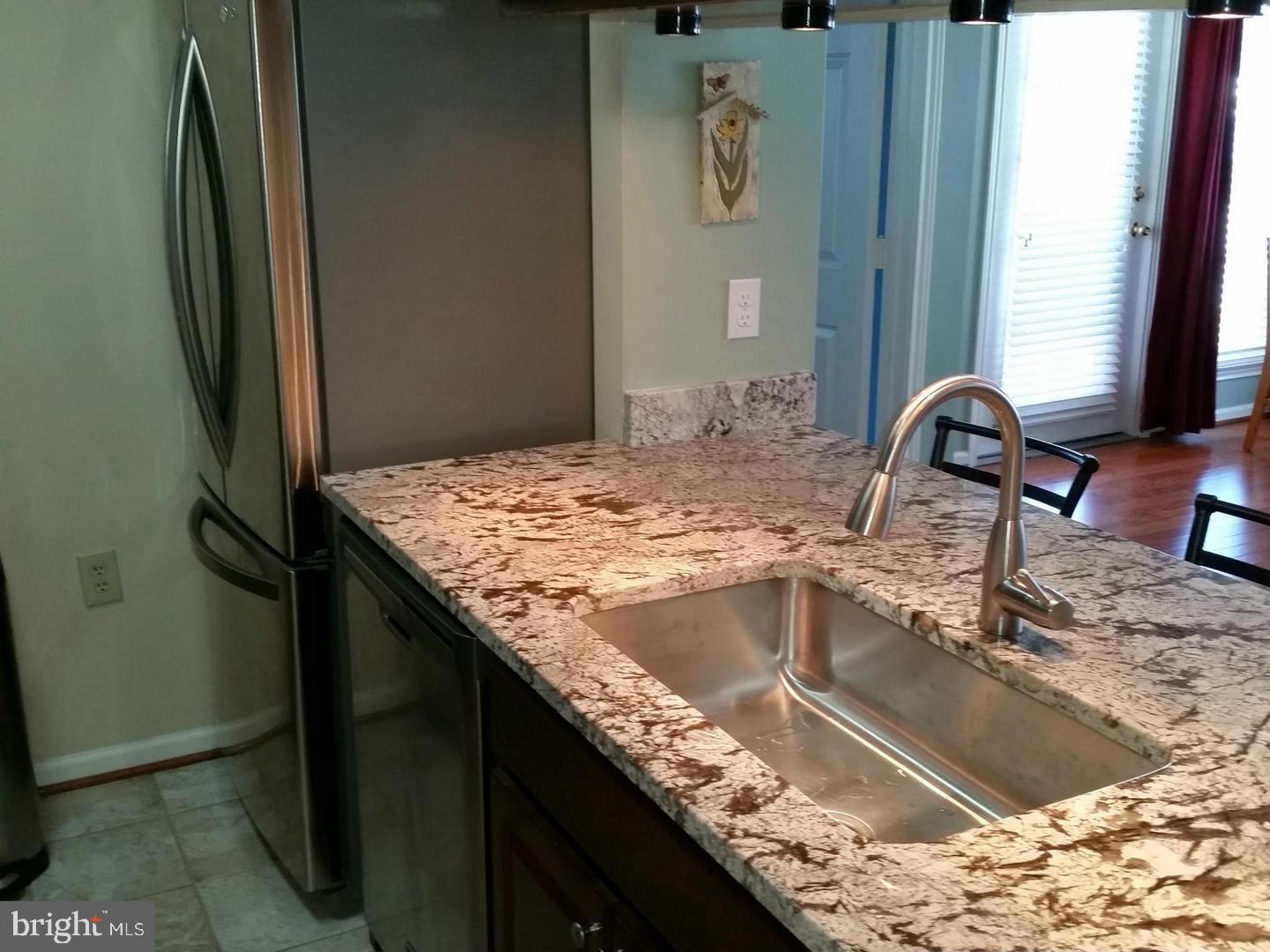 20952 Timber Ridge Terrace, Unit 104 Ashburn, VA 20147 - Photo 4 of 13 Kitchen with large sink & stainless appliances
