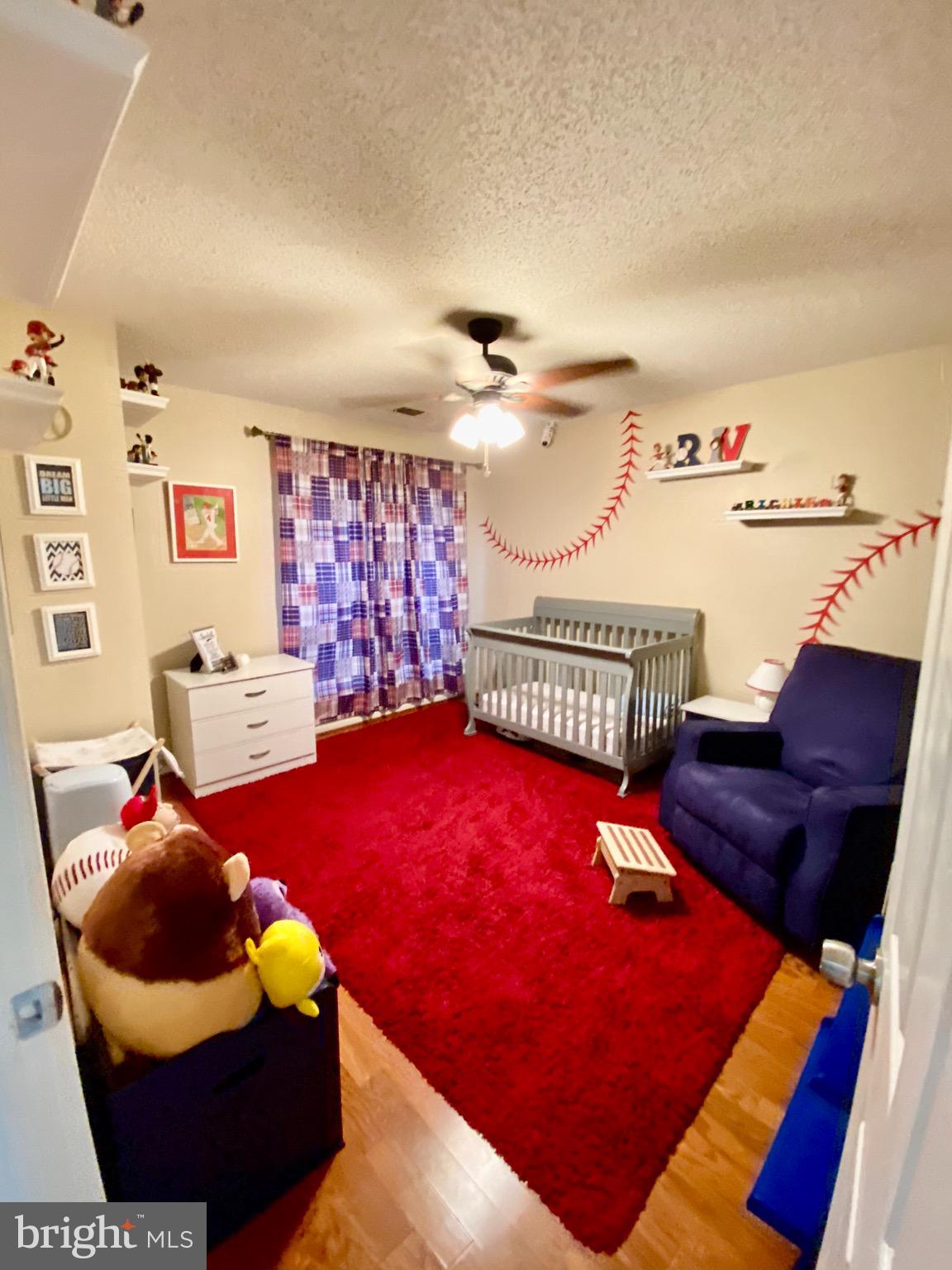 20952 Timber Ridge Terrace, Unit 104 Ashburn, VA 20147 - Photo 6 of 13 1st BR w/wood floor, walk-in closet & ceiling fan