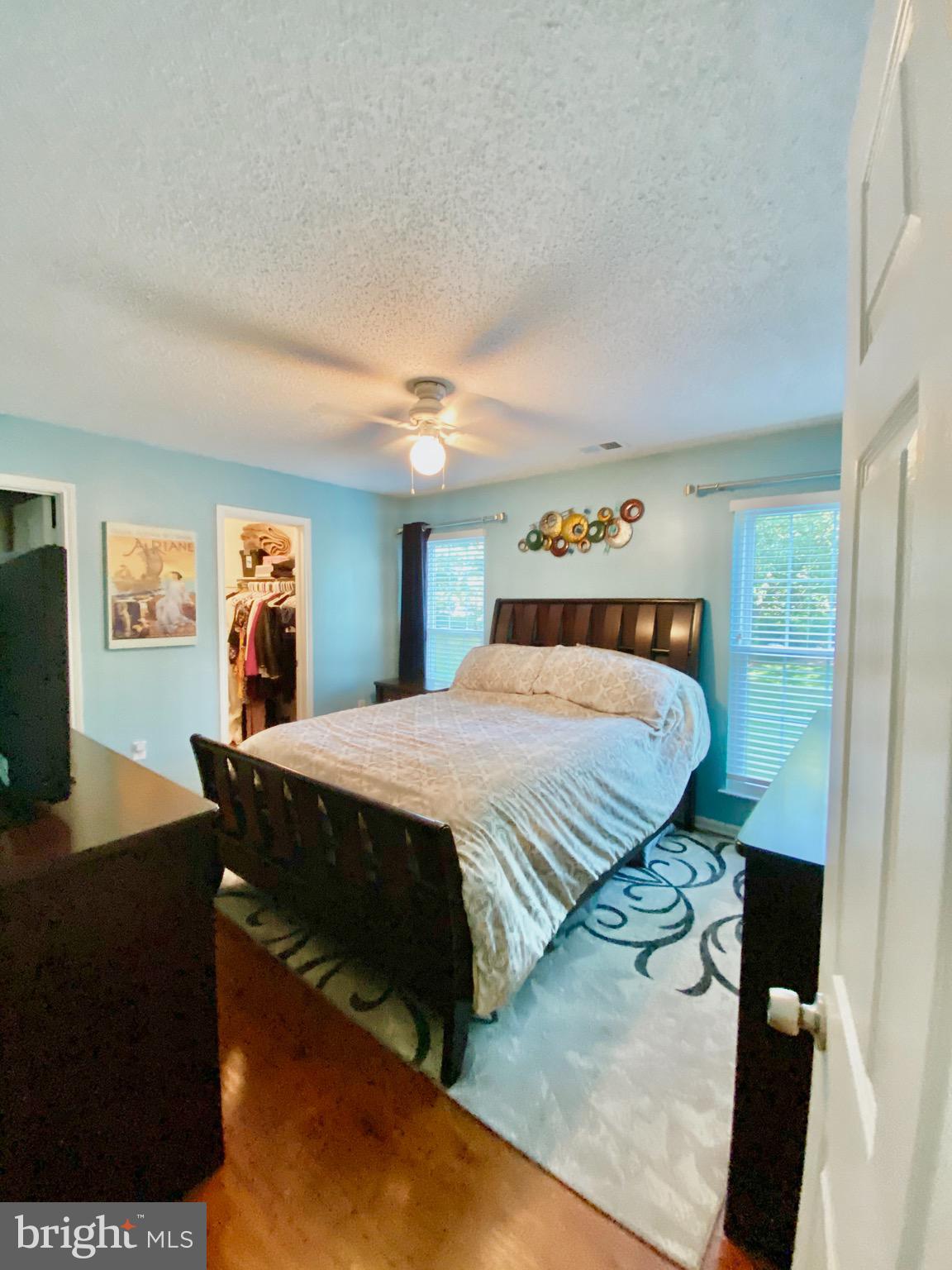 20952 Timber Ridge Terrace, Unit 104 Ashburn, VA 20147 - Photo 8 of 13 2nd BR w/ceiling fan, wood floor & walk-in closet