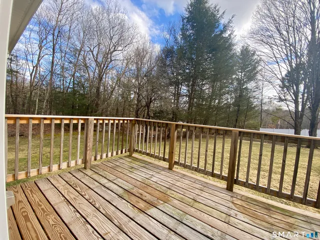 a view of balcony with wooden floor and fence