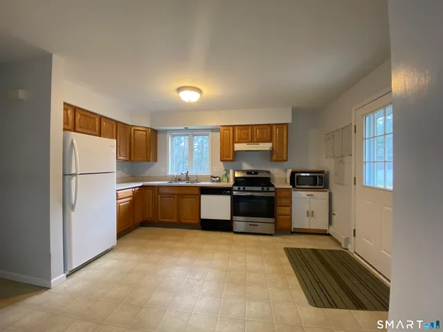 a kitchen with stainless steel appliances a refrigerator and a stove top oven