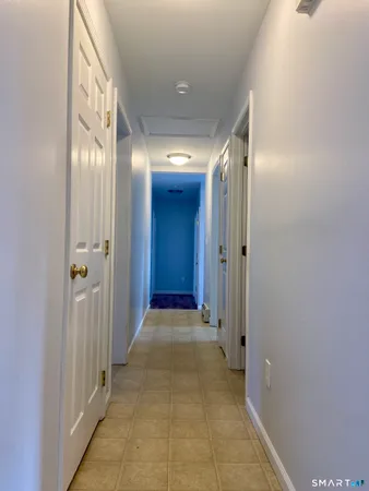 a view of a hallway with wooden shelves