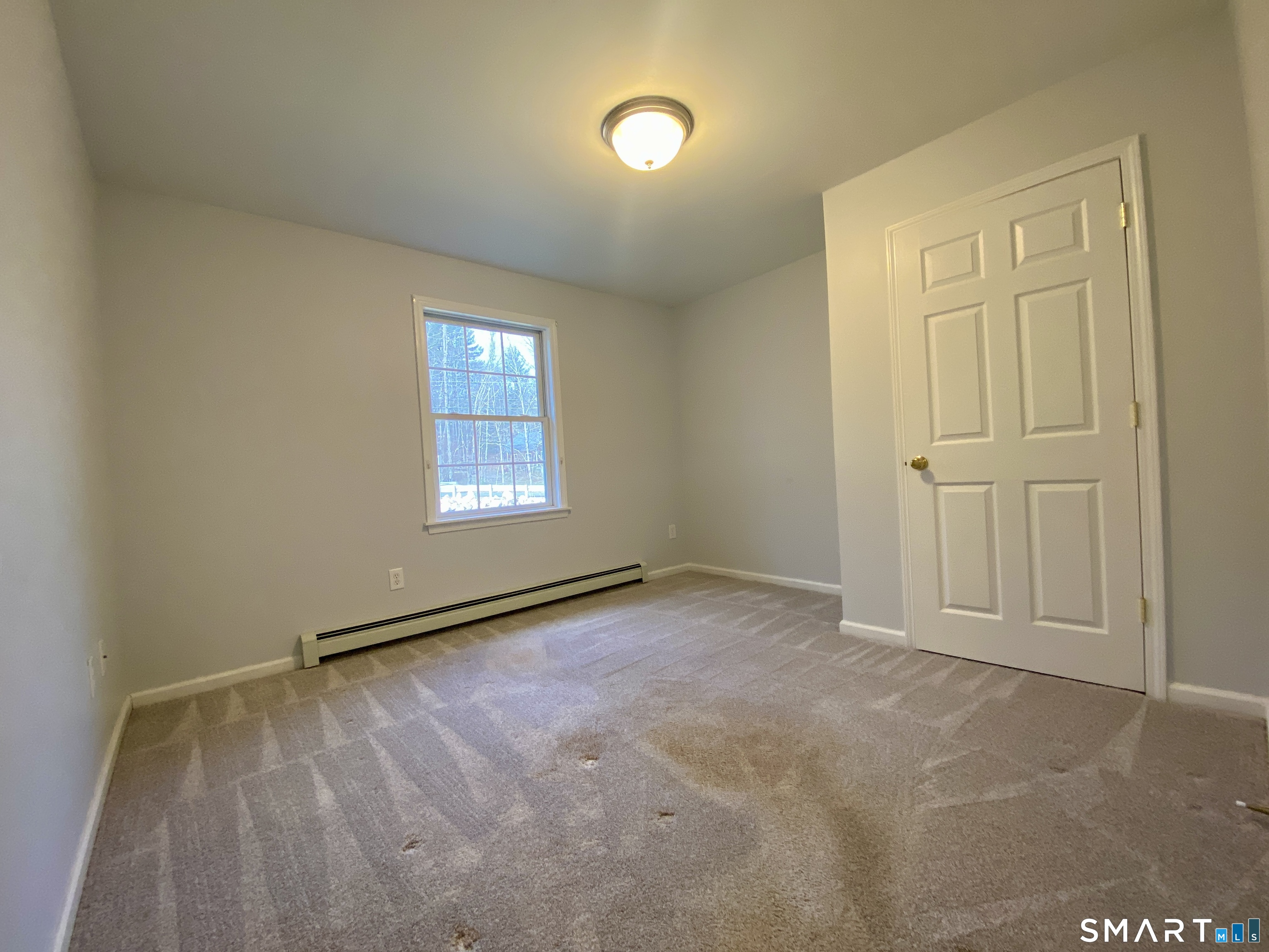 185 Whitbeck Road New Hartford, CT 06057 - Photo 8 of 18 an empty room with windows