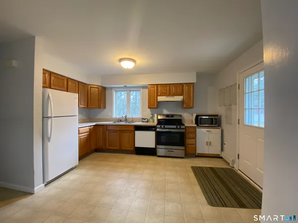 a kitchen with stainless steel appliances a refrigerator and a stove top oven
