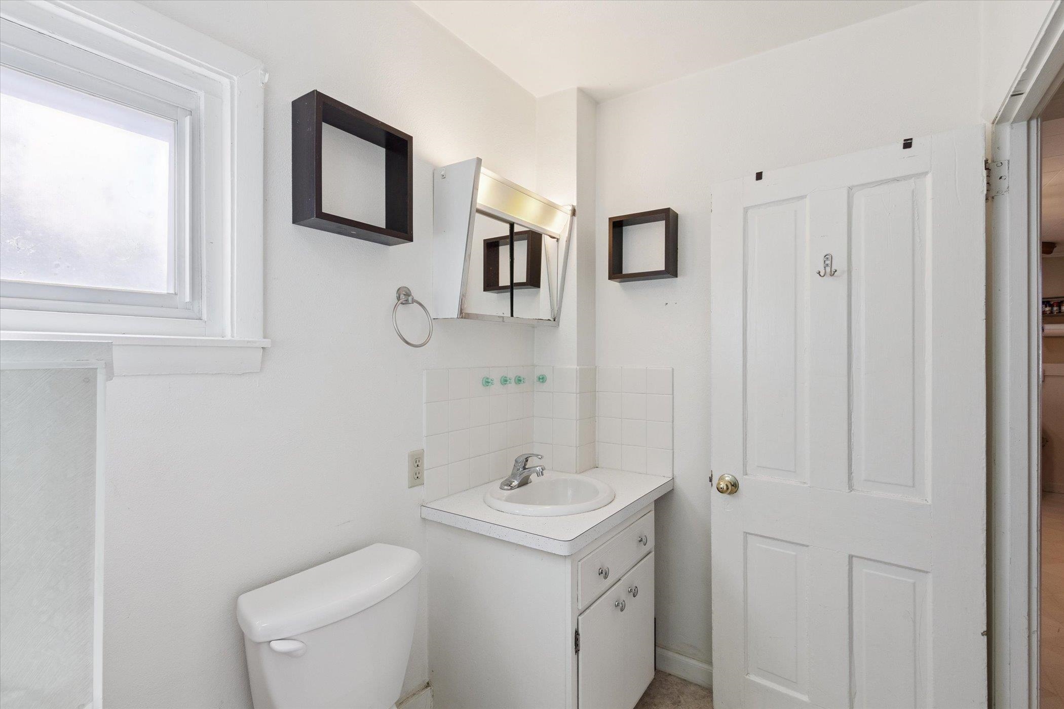 2683 West Florence Road Freeport, IL 61032 - Photo 21 of 36 a bathroom with a toilet sink and mirror