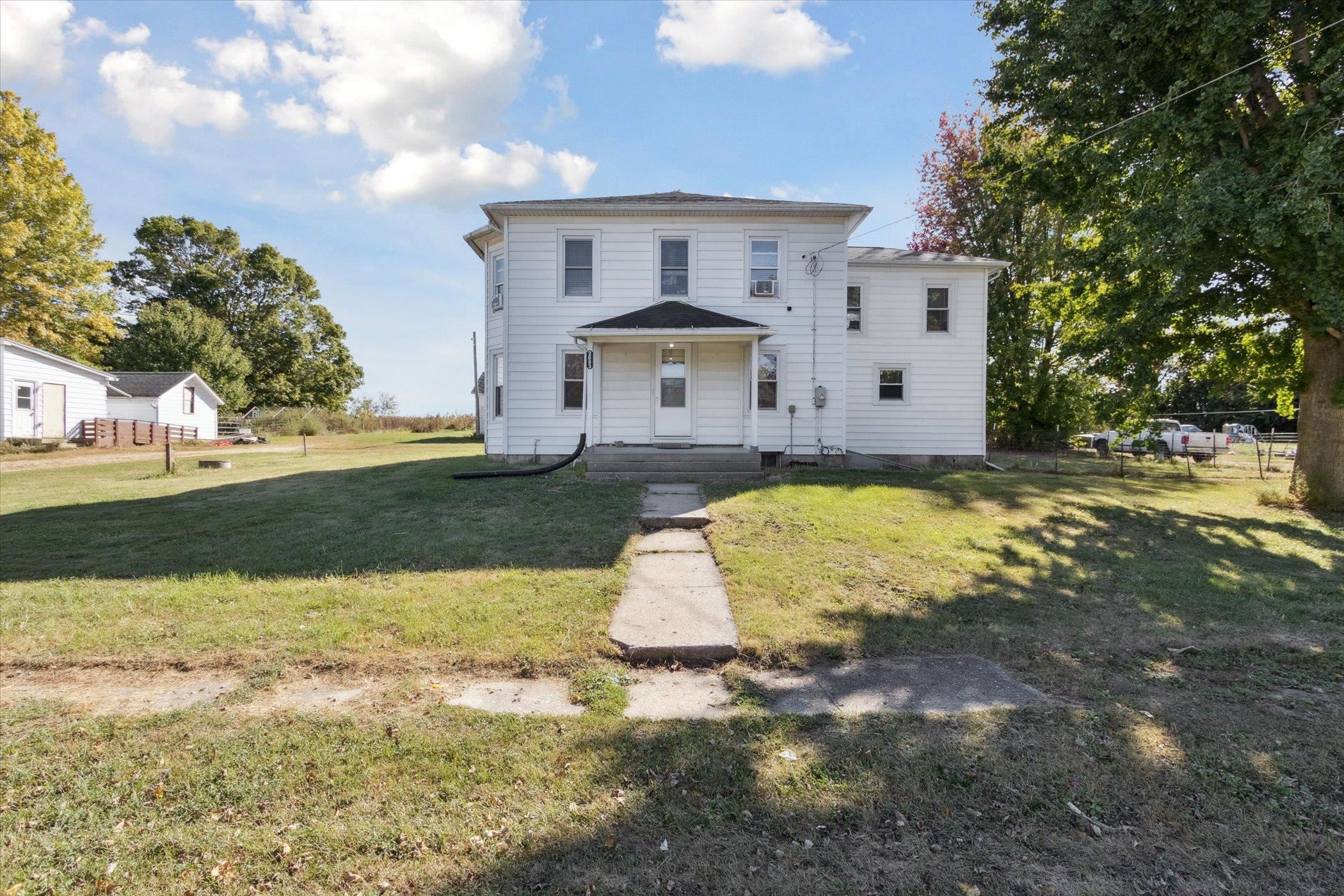 2683 West Florence Road Freeport, IL 61032 - Photo 3 of 36 a view of a white house with a big yard and large trees